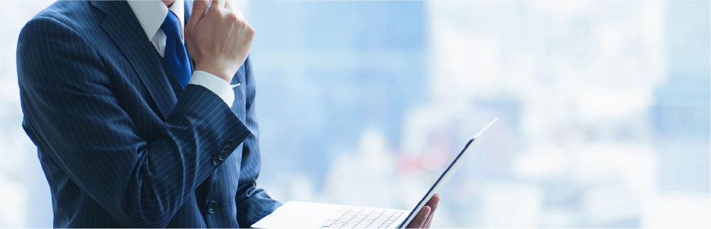 A man in corporate attire with laptop